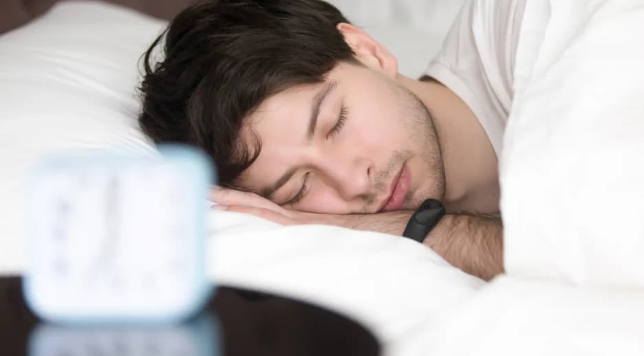 Man sleeping peacefully in bed, highlighting the sleep-quality benefits of wearing Specscart blue light glasses before nighttime digital use.