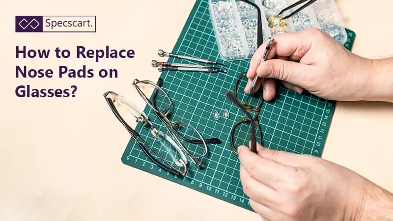 A pair of hands uses a small screwdriver to work on a pair of glasses, with replacement nose pads and other tools visible on a green cutting mat.