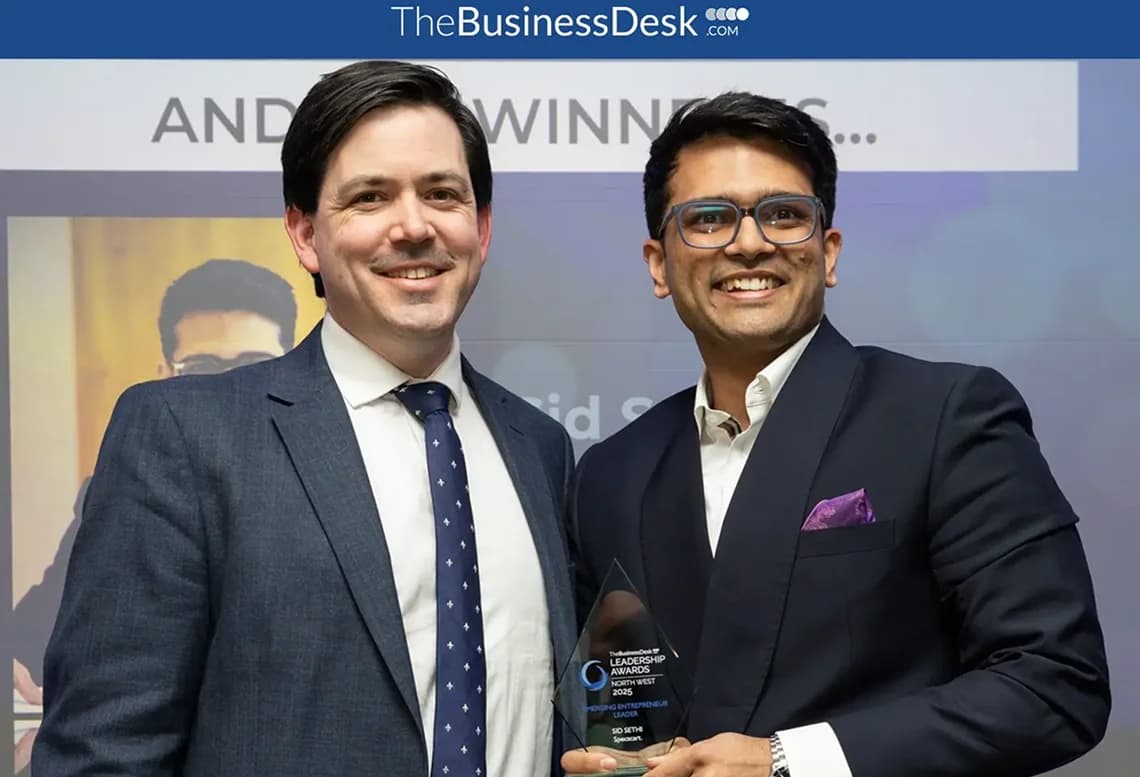 Specscart founder Sid Sethi receiving ‘the Emerging Entrepreneur Award’ from The Business Desk. The background features event signage and branding for the award presentation.