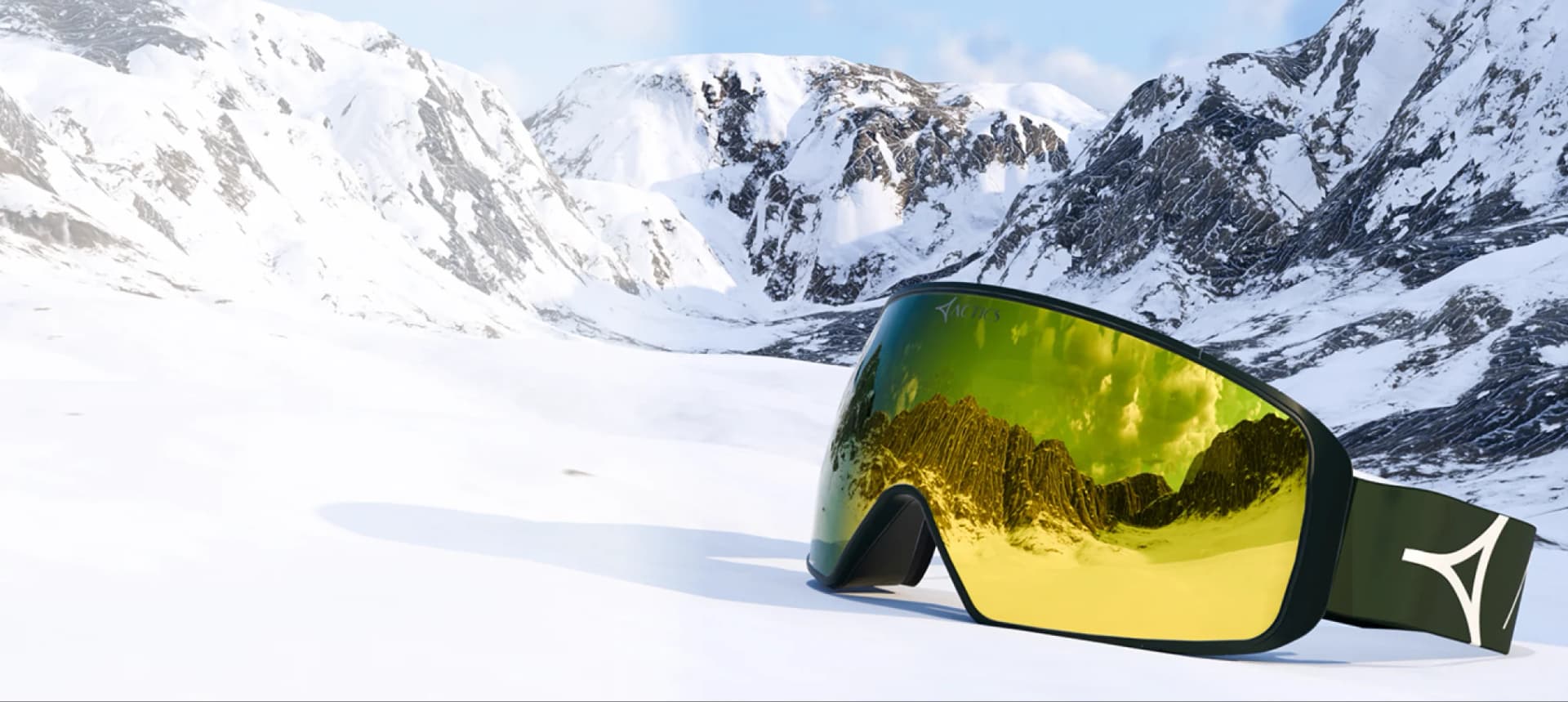 Ski goggles with mirrored golden lenses featured prominently against a snowy mountain backdrop. The reflective lenses show the rugged snow-capped peaks and cloudy sky, while the dark strap displays the Specscart Actics branding in white.