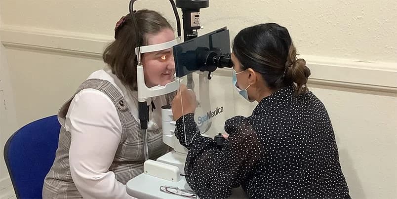 Optician conducting an eye test for a customer in a consultation room. The image promotes Specscart’s free eye test for everyone.