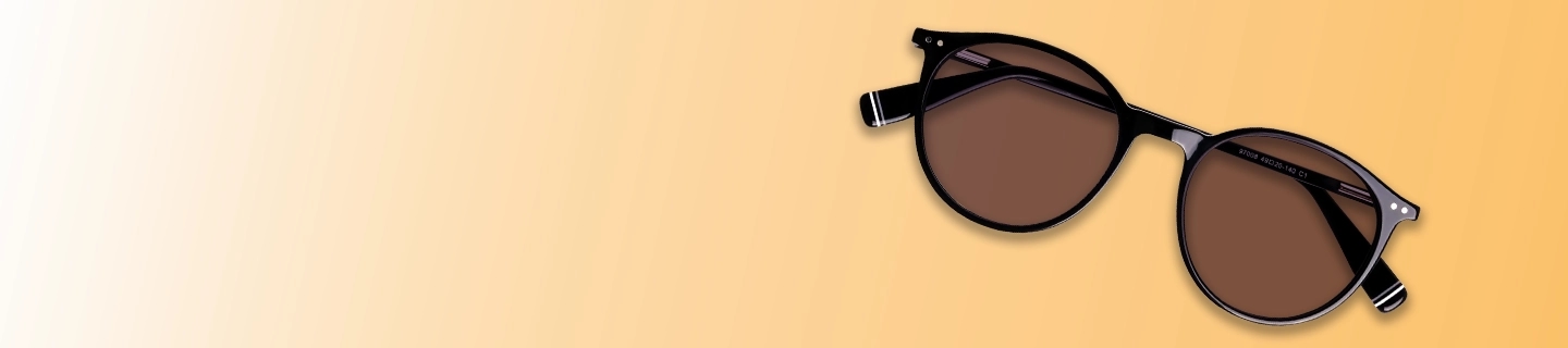 Discount Sunglasses A pair of classic round sunglasses with black frames and brown tinted lenses, laid flat against a warm yellow and cream gradient background.