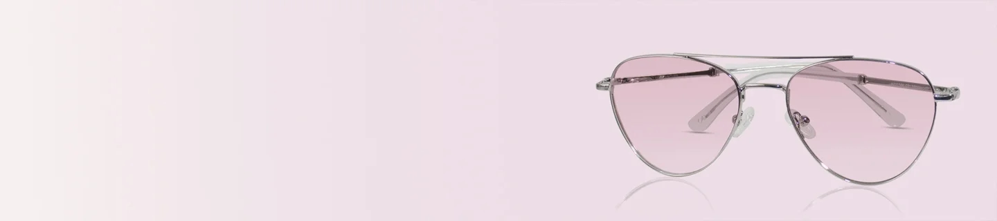 Pink Sunglasses A pair of classic silver-framed pilot sunglasses with soft pink-tinted lenses, displayed against a minimalist pastel pink gradient background.