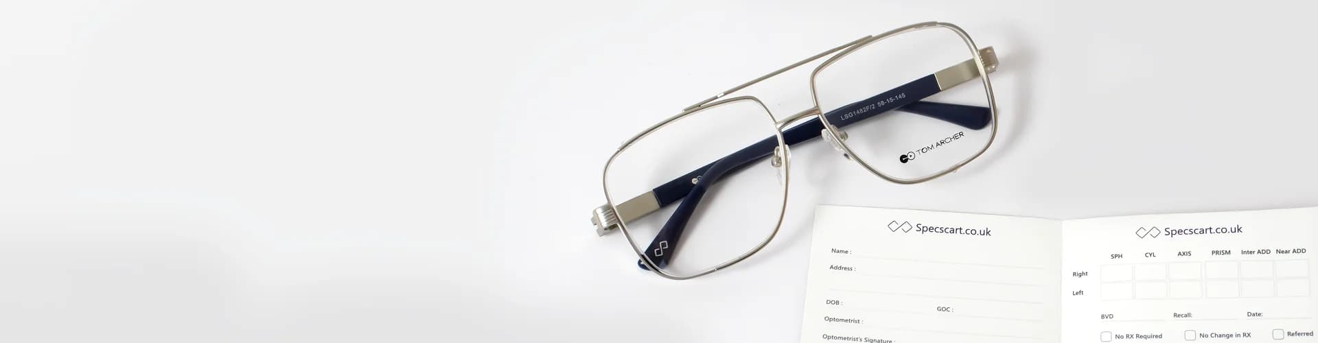 A pair of stylish gold-framed eyeglasses with black temples, resting beside two Specscart prescription pads showing fields for patient details and optical measurements, illustrating the topic of how to read an eyeglasses prescription.