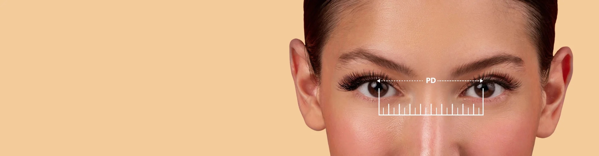 Image showing a person's eyes with a dashed line connecting the centre of their pupils labeled 'PD', and a ruler graphic below, demonstrating the process of measuring pupillary distance for glasses.