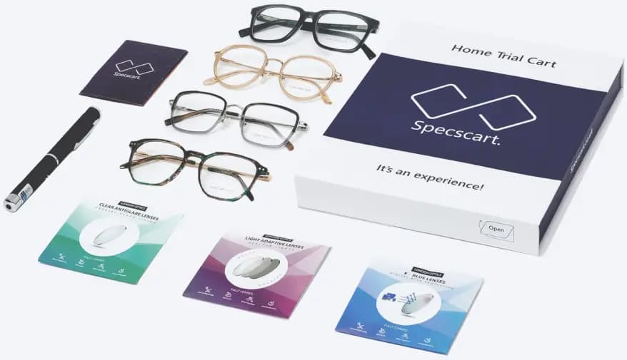 Image showing Specscart's home trial kit, including an open 'Home Trial Cart' box, four different eyeglasses frames, various lens samples in small cases, and a UV pen, representing the free home trial service offering 4 frames, 3 lenses, and 1 UV pen for 7 days.