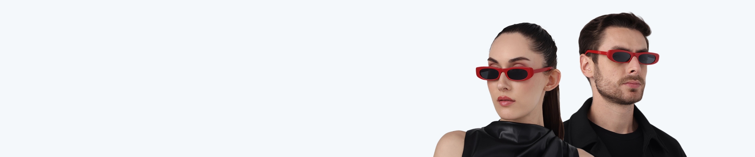 Red Sunglasses A stylish man and woman wearing slim rectangular red sunglasses with dark lenses, posing in black clothing against a clean white studio background.