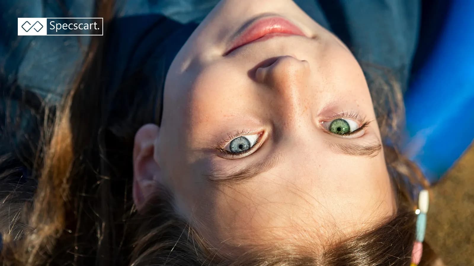 Heterochromia: The Science Behind Your Beautifully Mismatched Eyes A close-up, top-down view of a person with complete heterochromia, showing one bright blue eye and one vibrant green eye.