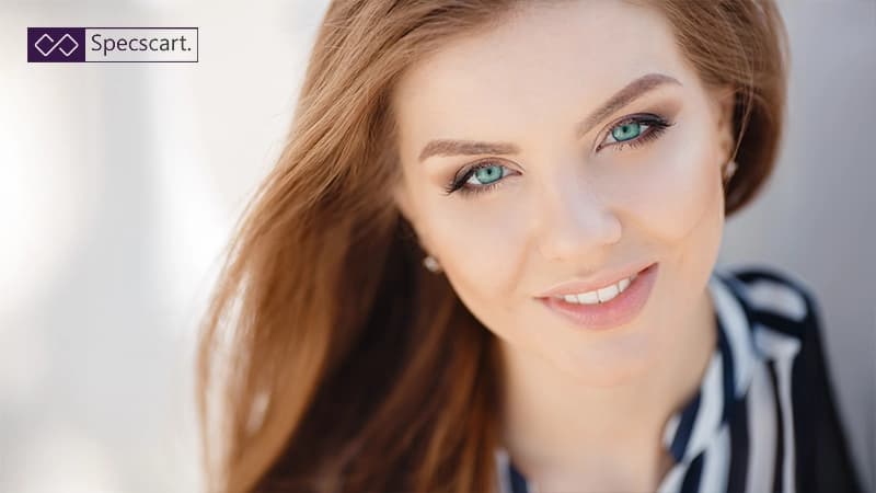 Why Green Eyes Are Considered to be Most Attractive? A beautiful woman with flowing auburn hair and striking turquoise-green eyes.