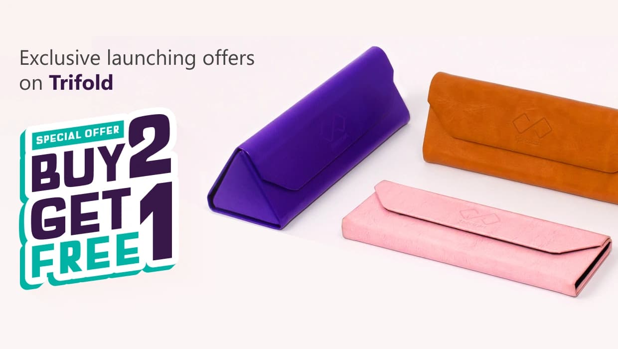 Banner advertising ‘Exclusive Launching Offer On Trifold, Buy 2 Get 1 Free’ featuring three pastel-coloured Specscart trifold cases in pink, purple, and brown, arranged in pairs on a pale background.