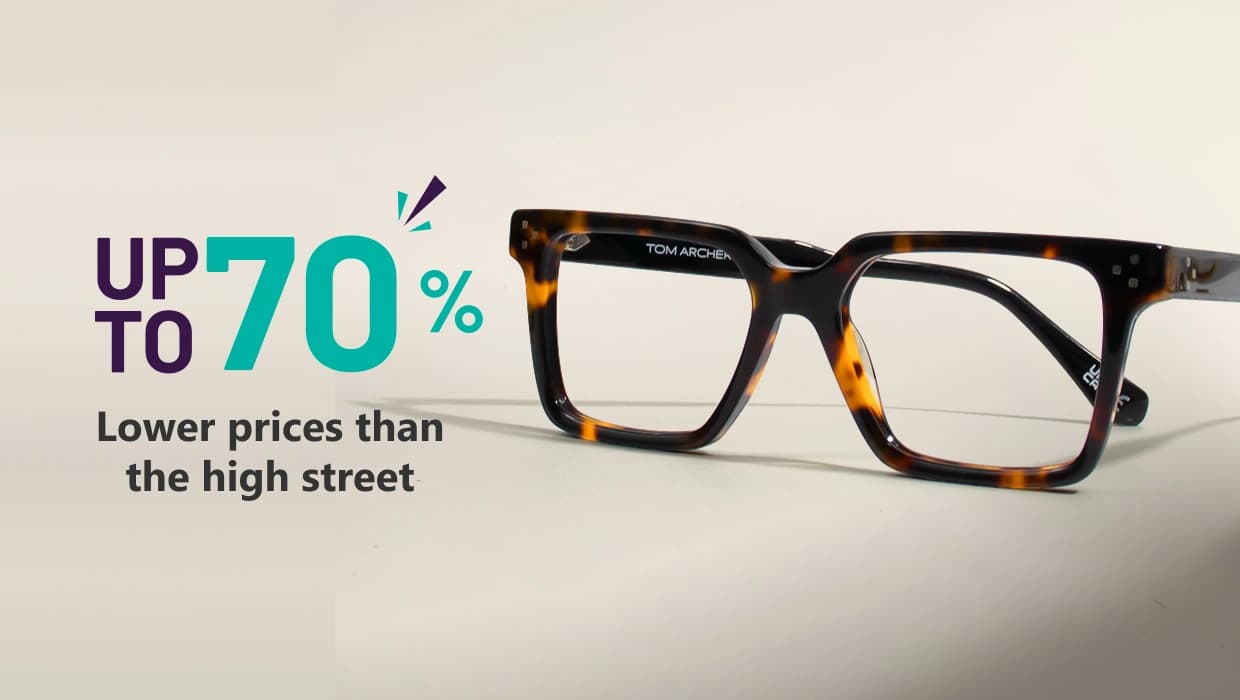 Banner highlighting ‘Eyewear At 70% Off, Less Cost Than High Street’ with large blue text and a pair of geometric blue-rimmed Specscart glasses on the right side, set against a simple pale backdrop.