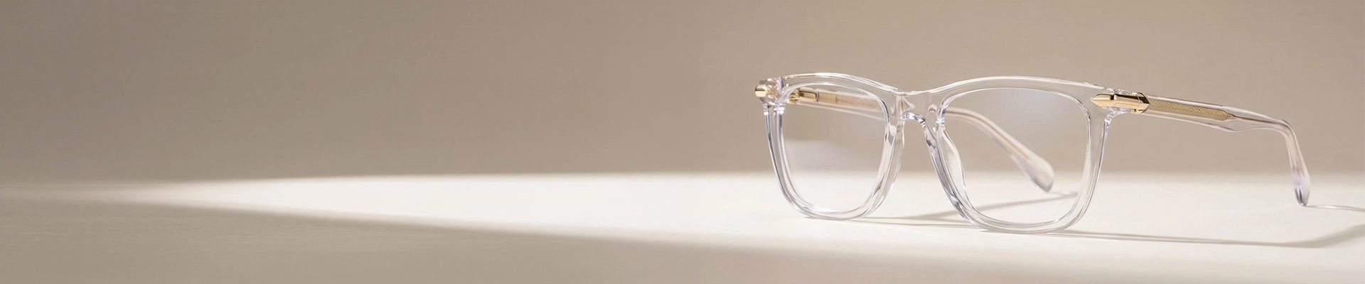 Clear Glasses The image features a close-up of clear acetate eyeglasses in a chunky rectangular frame that is placed on a white stand against a light grey background. The image has content that says Clear Glasses. It also has a discount offer by Specscart and Trustpilot reviews.