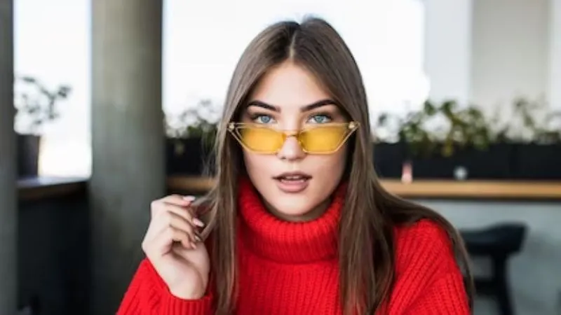 Image of a woman wearing tinted glasses indoors