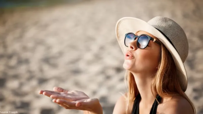  An image of a
woman wearing sunglasses on the beach