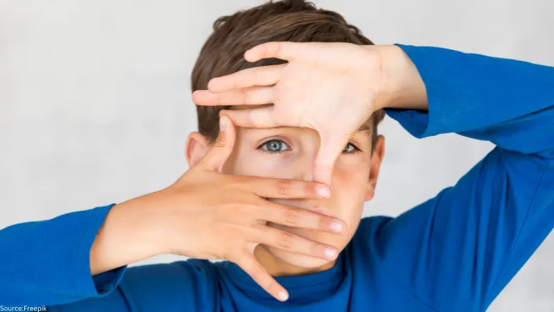 Boy making frame with his fingers