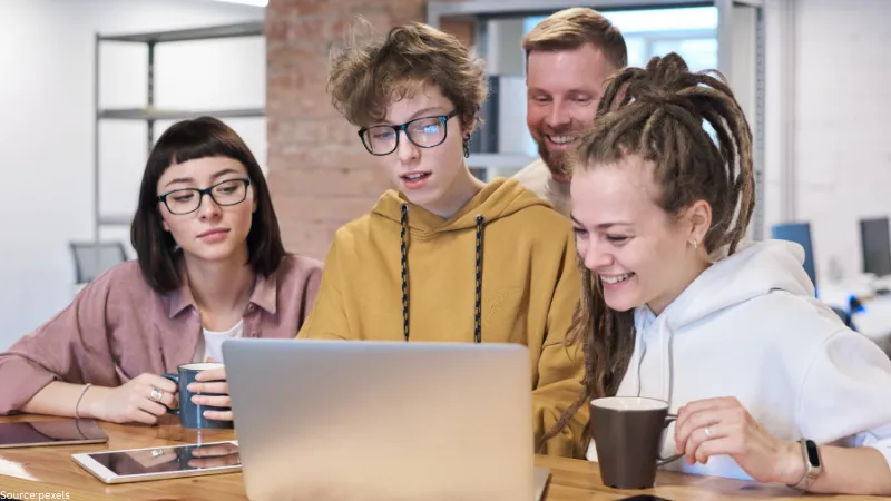 group of people looking at laptop